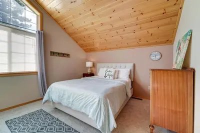 a bedroom with a bed and a wooden ceiling at 4 Mi to Downhill Ski Resort! Spacious Family Haven in Truckee