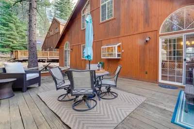 a patio with a table and chairs on a wooden deck at 4 Mi to Downhill Ski Resort! Spacious Family Haven in Truckee