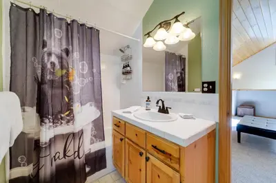 a bathroom with a sink and a shower curtain at 4 Mi to Downhill Ski Resort! Spacious Family Haven in Truckee