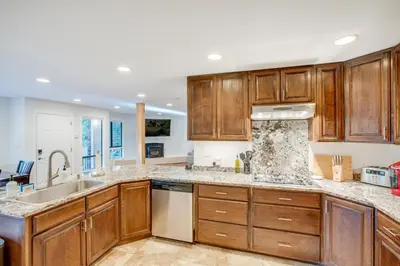 a kitchen with wooden cabinets and a sink at Pollock Pines Cabin Game Room with AandC and Heat! in Pollock Pines