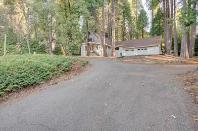 a driveway leading to a house in the woods at Pollock Pines Cabin Game Room with AandC and Heat! in Pollock Pines