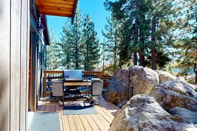 a grill on a deck next to some rocks at Hilltop Lodge in Stateline