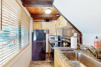 a kitchen with a sink and a refrigerator at Hilltop Lodge in Stateline