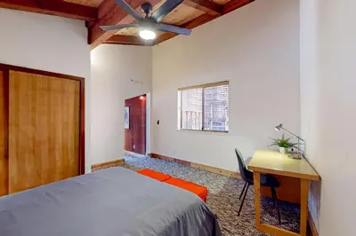 a bedroom with a bed and a desk and a window at Hilltop Lodge in Stateline