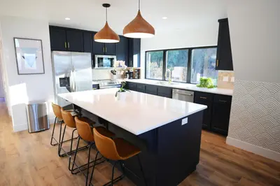 a kitchen with a large island with a white counter top at High End A-Frame - Hot Tub - Awesome Views - Yosemite - Electric Vehicle Friendly - Sleeps 10 in Oakhurst