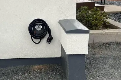 a black hose is attached to the side of a building at High End A-Frame - Hot Tub - Awesome Views - Yosemite - Electric Vehicle Friendly - Sleeps 10 in Oakhurst