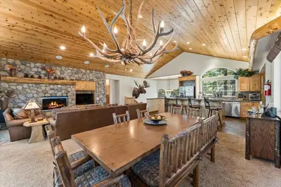 a dining room with a table and a fireplace at Getting Away Together home in South Lake Tahoe