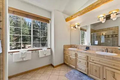 a bathroom with two sinks and a large window at Getting Away Together home in South Lake Tahoe