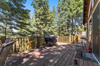 a deck with chairs and a grill on a house at Getting Away Together home in South Lake Tahoe