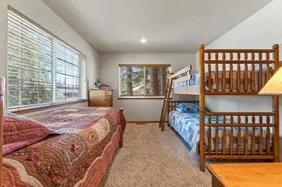 a bedroom with a bunk bed and a ladder at Getting Away Together home in South Lake Tahoe
