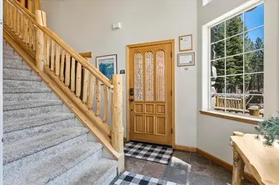 a home with a staircase and a wooden door at Getting Away Together home in South Lake Tahoe