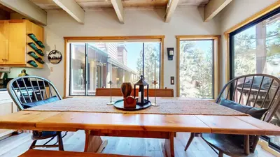 a dining room with a wooden table and chairs at Val D'Isere #8 condo in Mammoth Lakes