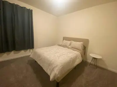 a small bedroom with a bed and a table at Cozy hideaway 30 miles to Mt Rose Ski, Tahoe/ Reno in Reno