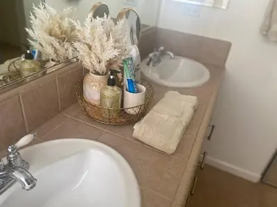 a bathroom with a sink and a mirror and two sinks at Cozy hideaway 30 miles to Mt Rose Ski, Tahoe/ Reno in Reno