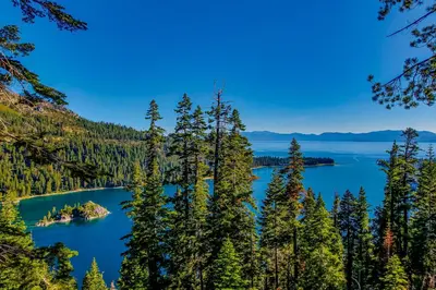 an island in the middle of a lake surrounded by trees at Lakeland Village South Lake Tahoe in South Lake Tahoe
