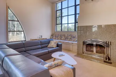 a living room with a couch and a fireplace at Remarkable Roundhouse Retreat in Truckee