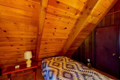 a bedroom with a bed and a wooden ceiling at Tranquil Treehouse Haven in Tahoe City