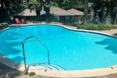 a large pool with blue water in a yard at Sierra Park Villas 11 C in Mammoth Lakes
