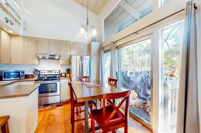 a kitchen with a wooden table and chairs in it at Sierra Park Villas 11 C in Mammoth Lakes