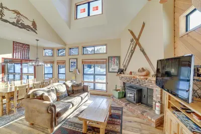 a living room with a couch and a tv and a fireplace at Mammoth Lakes Condo - Steps to Ski Lift! in Mammoth Lakes