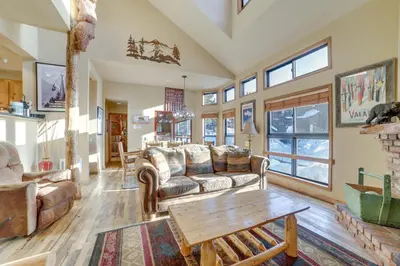 a living room with couches and a table at Mammoth Lakes Condo - Steps to Ski Lift! in Mammoth Lakes