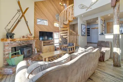 a living room with couches and a fireplace at Mammoth Lakes Condo - Steps to Ski Lift! in Mammoth Lakes