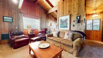 a living room with a couch and a table at Villa de los Pinos #40 condo in Mammoth Lakes