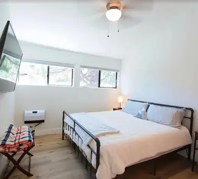 a bedroom with a large bed and a chair at New Listing 2 bedroom +Loft 2 bath Summit E Bldg. #8 condo sleeps 8, Steps to Eagle Lodge/Chair #15 in Mammoth Lakes