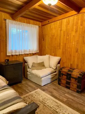 a living room with a couch and a window at Vintage 1857~Stone & Beam Cellar in Amador City