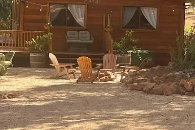 a patio with chairs and a table in front of a house at B-B Ranch Cottage~Heart of Gold Country~*HOT TUB* in Pilot Hill