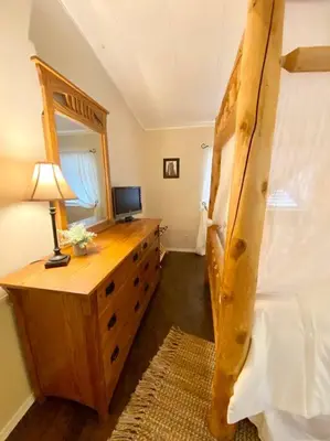 a bedroom with a bed and a desk with a lamp at B-B Ranch Cottage~Heart of Gold Country~*HOT TUB* in Pilot Hill