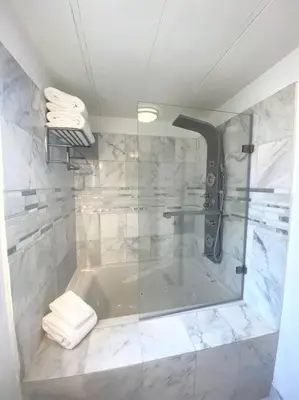 a bathroom with a tub and a glass shower at B-B Ranch Cottage~Heart of Gold Country~*HOT TUB* in Pilot Hill