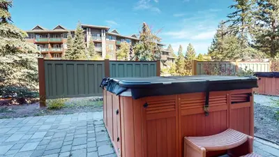 a wooden fence with a bench in a yard at Juniper Crest #2 townhouse in Mammoth Lakes