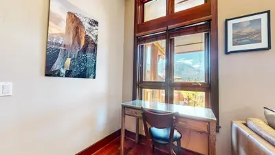 a desk with a chair next to a window at Juniper Crest #2 townhouse in Mammoth Lakes