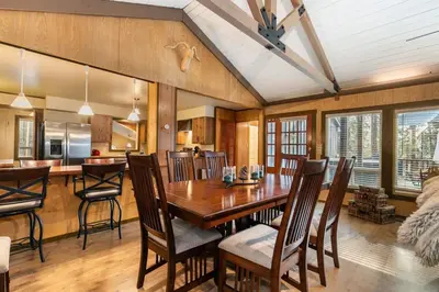 a kitchen and dining room with a wooden table and chairs at Classic 3BD Tahoe Cabin with Hot Tub in Carnelian Bay