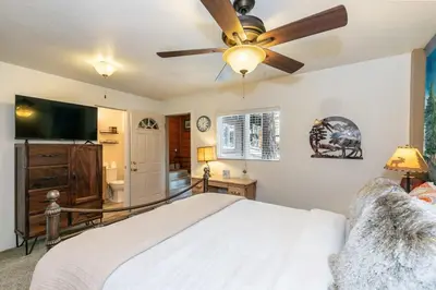 a bedroom with a bed and a ceiling fan at Classic 3BD Tahoe Cabin with Hot Tub in Carnelian Bay