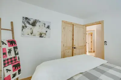a bedroom with a bed and a picture on the wall at Arnold Cabin Near Calaveras Big Trees State Park! in Arnold