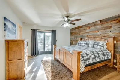 a bedroom with a bed and a ceiling fan at Arnold Cabin Near Calaveras Big Trees State Park! in Arnold