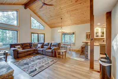a living room with a couch and a table at Arnold Cabin Near Calaveras Big Trees State Park! in Arnold