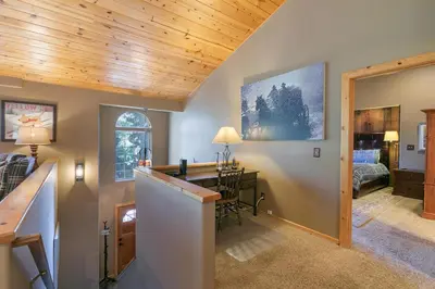 a home office with a desk and a bedroom at Alpen Glow by Tahoe Getaways - Private Hot Tub, Close to Northstar in Carnelian Bay
