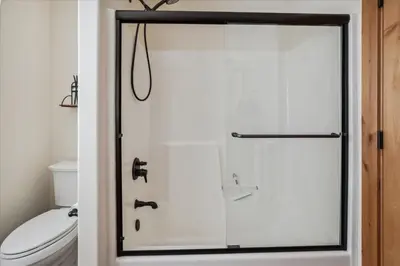a bathroom with a shower with a toilet at Agate Bay Gem by Tahoe Getaways - Charming Getaway with Cozy Fireplace Near Hiking and Biking Trails in Tahoe Vista