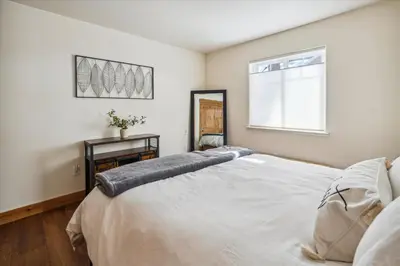 a bedroom with a large white bed and a window at Agate Bay Gem by Tahoe Getaways - Charming Getaway with Cozy Fireplace Near Hiking and Biking Trails in Tahoe Vista
