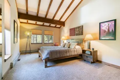 a bedroom with a bed and a wooden ceiling at Alpine Escape by Tahoe Getaways - Shuttle to Ski Slopes & Fireplace in Alpine Meadows