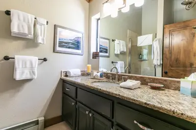 a bathroom with a sink and a large mirror at Alpine Escape by Tahoe Getaways - Shuttle to Ski Slopes & Fireplace in Alpine Meadows