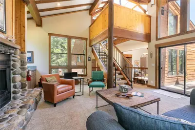 a living room filled with furniture and a fireplace at Alpine Escape by Tahoe Getaways - Shuttle to Ski Slopes & Fireplace in Alpine Meadows