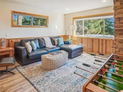 a living room with a couch and a table at Bear Peak Cabin by Tahoe Getaways - Tahoe Donner Rental with Private Hot Tub and Bonus Room in Truckee