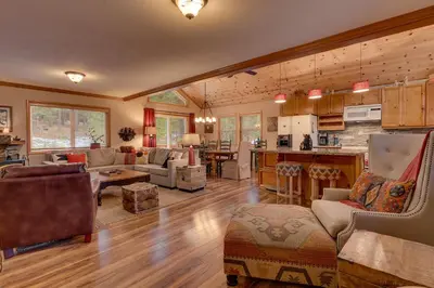 a living room with a kitchen and a living room at Bear's Lair by Tahoe Getaways - 3 BR in Tahoe Donner with Hot Tub & Bonus Room! in Truckee
