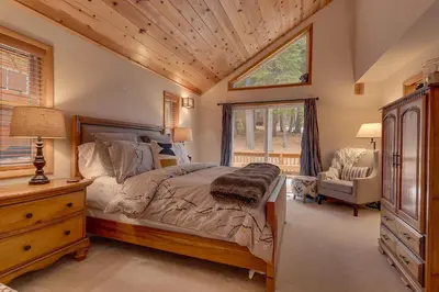 a bedroom with a bed and a dresser and a window at Bear's Lair by Tahoe Getaways - 3 BR in Tahoe Donner with Hot Tub & Bonus Room! in Truckee