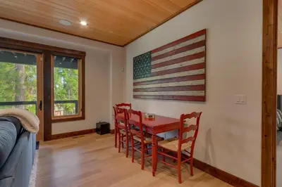 a dining room with an american flag on the wall at Bluebird Lodge by Tahoe Getaways - 4 BR with Hot Tub, Pool Table & Lake Views in Carnelian Bay