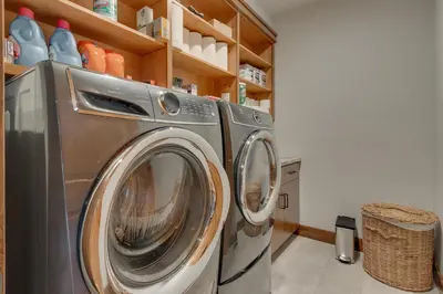 a washer and dryer in a laundry room at Bluebird Lodge by Tahoe Getaways - 4 BR with Hot Tub, Pool Table & Lake Views in Carnelian Bay